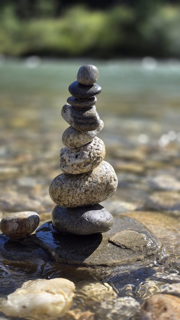 gallery-2 Tranquil stone stack at a riverside in Bhutan, capturing nature's harmony and balance.